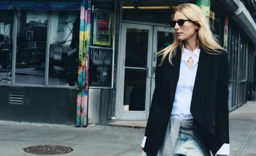 A woman in sunglasses and an oversized coat